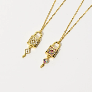 Detail view of 14k gold plated heart lock pendants with micro-pave colorful zircon stones