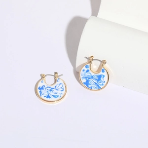 Blue porcelain enamel hoop earrings in 14k gold plating with white marble texture