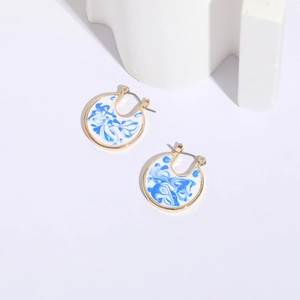 Blue and white porcelain enamel hoop earrings with 14k gold plating on a white aesthetic background