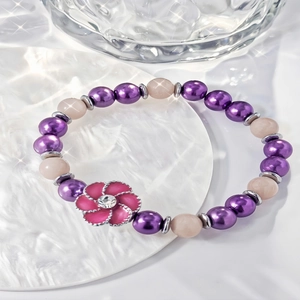 Glow-in-the-dark rotating sunflower beaded bracelet with purple and pink glowing beads