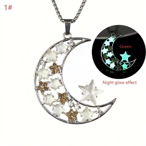 Detailed view of crescent moon pendant with star accents showing green night glow effect