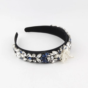 Detailed close-up of Baroque headband with blue crystals and pearl star patterns