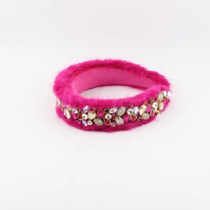 Detail of rose red faux fur headband featuring luxury rhinestones and gemstones