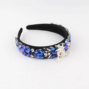 Detailed view of the luxury baroque headband with blue crystals and hanging pearl tassel