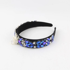 Detail of Baroque headband with blue crystals, white pearls and velvet base on white background