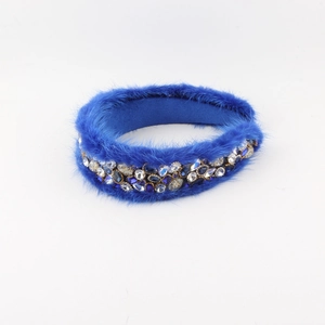 Detailed close-up of luxurious royal blue faux fur headband with embedded rhinestones