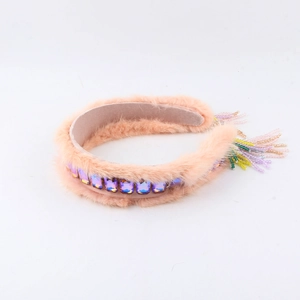 Close-up of pink mink fur headband featuring crystal gems and multi-color beaded tassels