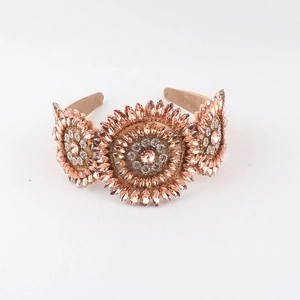 Detail of baroque crystal headband with champagne sunflower jewel patterns on suede base