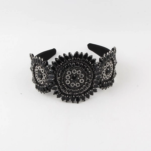 Detail of vintage black crystal beaded headband with handmade sunflower patterns