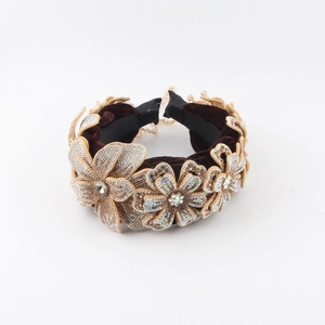 Close-up of velvet headband with crystal floral embroidery and shimmering rhinestones