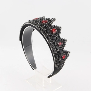 Close-up of Baroque black tiara with red water-drop rhinestones and gothic crystal details