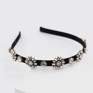 Minimalist woven headband with rhinestone flower clusters and faux pearls on a black frame