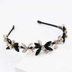 Elegant hand-woven headband with crystal floral petals on a minimalist black frame