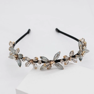 Detail of hand-woven headband featuring grey crystal petals and white rhinestone centers