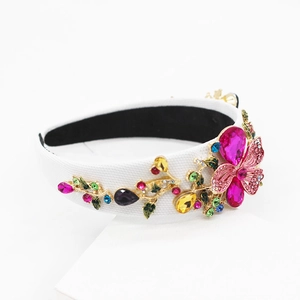 Detailed view of Baroque headband with pink rhinestone butterfly and colorful gems