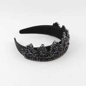 Macro shot of Baroque black bridal crown featuring intricate purple gems and rhinestones