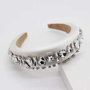 Close-up of luxury white sponge headband with multi-cut rhinestones on geometric stand