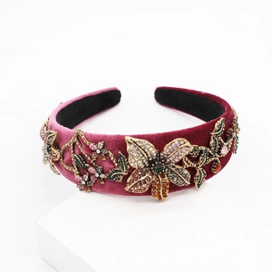 Close-up of luxury Baroque padded headband with colorful rhinestones and gold flowers