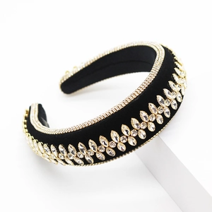 Detail view of black velvet headband with sparkling rhinestones and crystal leaf patterns