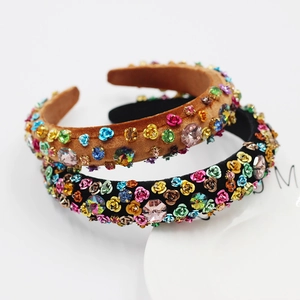 Détail de bandeaux baroques en velours avec strass colorés et fleurs en métal