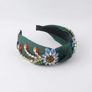 Detail of dark green knot headband featuring embroidered flowers and crystal embellishments