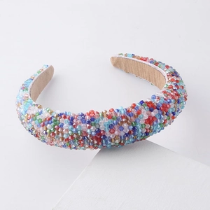 Close-up of vibrant crystal beads and soft tan velvet lining on a fashion headband