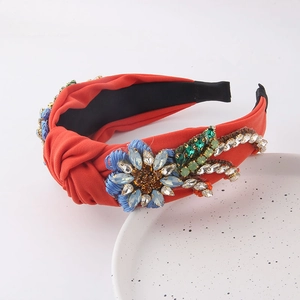 Detail of orange knotted headband featuring handcrafted blue crystal flowers and beadwork