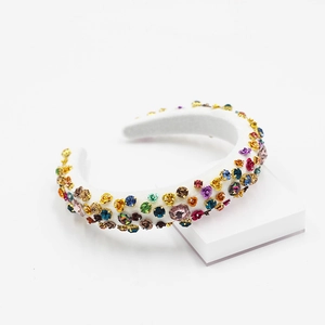 Baroque style padded headband with colorful rhinestones and metal flowers on white velvet