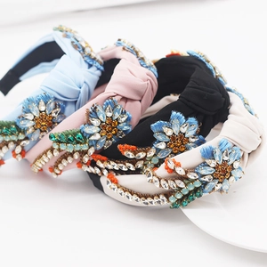 Detail of four fabric headbands with 3D floral embroidery and colorful rhinestones