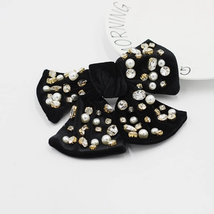 Détail du nœud papillon en velours noir avec perles blanches et strass brillants