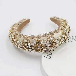 Detailed macro view of baroque headband with rhinestones and faux pearls on fabric