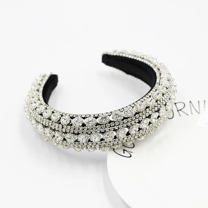 Macro detail of luxury baroque headband with silver crystals and black inner lining