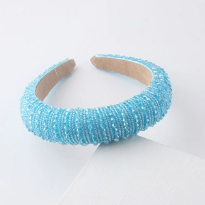 Detailed macro view of light blue crystal beads on a padded sponge headband structure