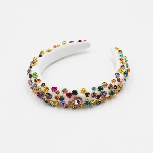 Detailed macro of white sponge headband with colorful rhinestones and floral jewels
