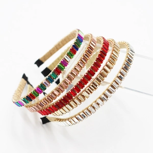 Detailed view of colorful baroque headbands with gold edges and rectangular rhinestones