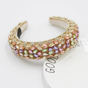 Luxury Baroque headband with colorful rhinestones and gold chain on beige silk fabric