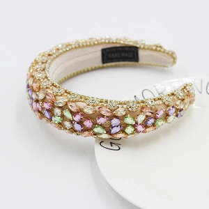 Baroque luxury padded headband featuring colorful rhinestones and gold chain trim