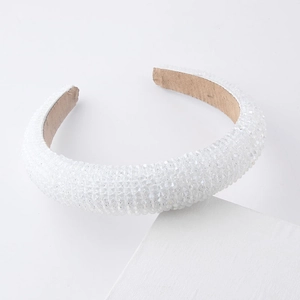 Close-up of white crystal beaded padded headband with non-slip suede inner lining