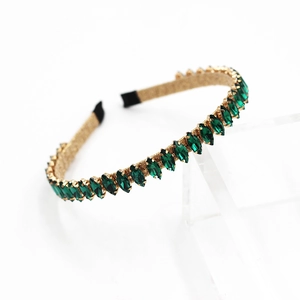 Baroque golden headband with marquise-cut green crystals on a transparent display stand