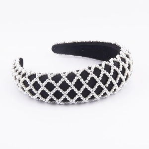 Detail of sponge mesh headband with white pearls arranged in a diamond grid pattern
