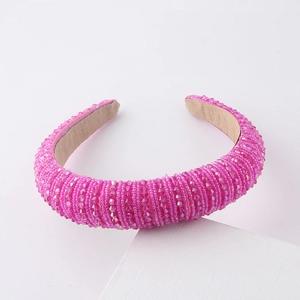 Close-up of pink crystal beads on wide sponge headband with luxury pearl texture