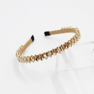 Detailed shot of Baroque headband with marquise-cut champagne crystals on gold metal