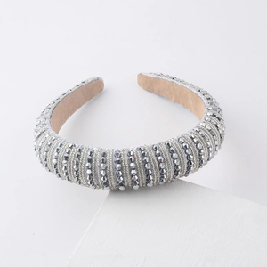 Close-up of padded headband featuring silver crystals and metallic thread details