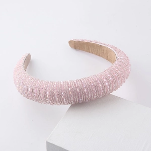 Macro view of pink crystal beads on wide sponge headband with soft velvet lining