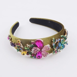 Detailed close-up of olive green velvet headband with colorful rhinestones and pink butterfly