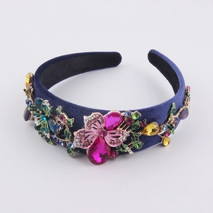 Close-up of velvet headband with colorful rhinestones and vintage floral metal details