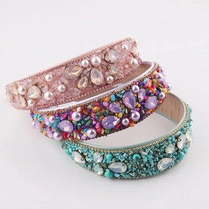 Detailed view of baroque wide headbands with colorful rhinestones and pearls