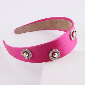 Detail of rose red satin wide headband featuring sparkling crystal rhinestone embellishments