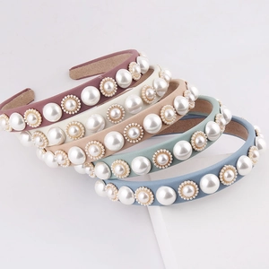 Detail view of five milk silk headbands with elegant pearls and non-slip suede lining
