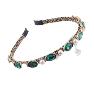 Elegant gold woven headband featuring green emerald-cut stones and white pearls